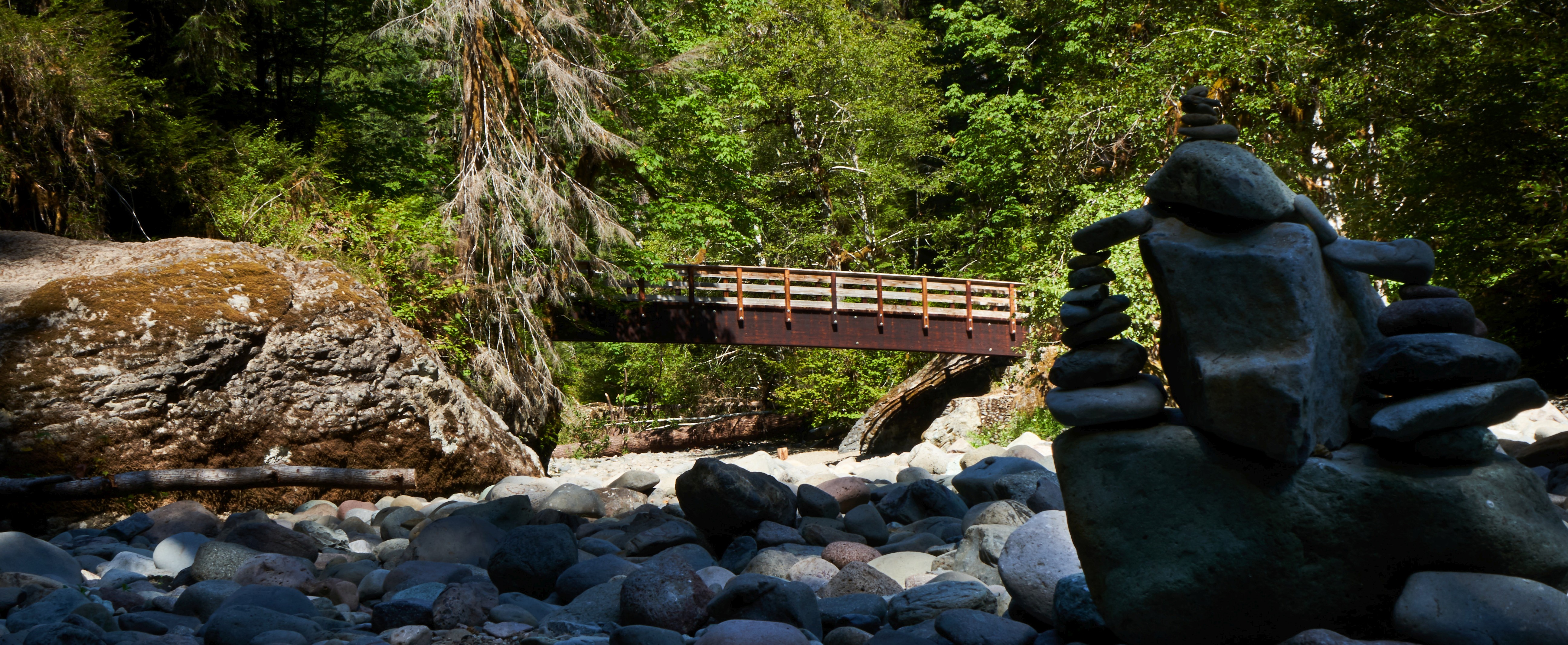 Rocks stacked by bridge